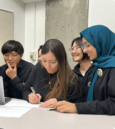 Group of students working together to solve a coding challenge