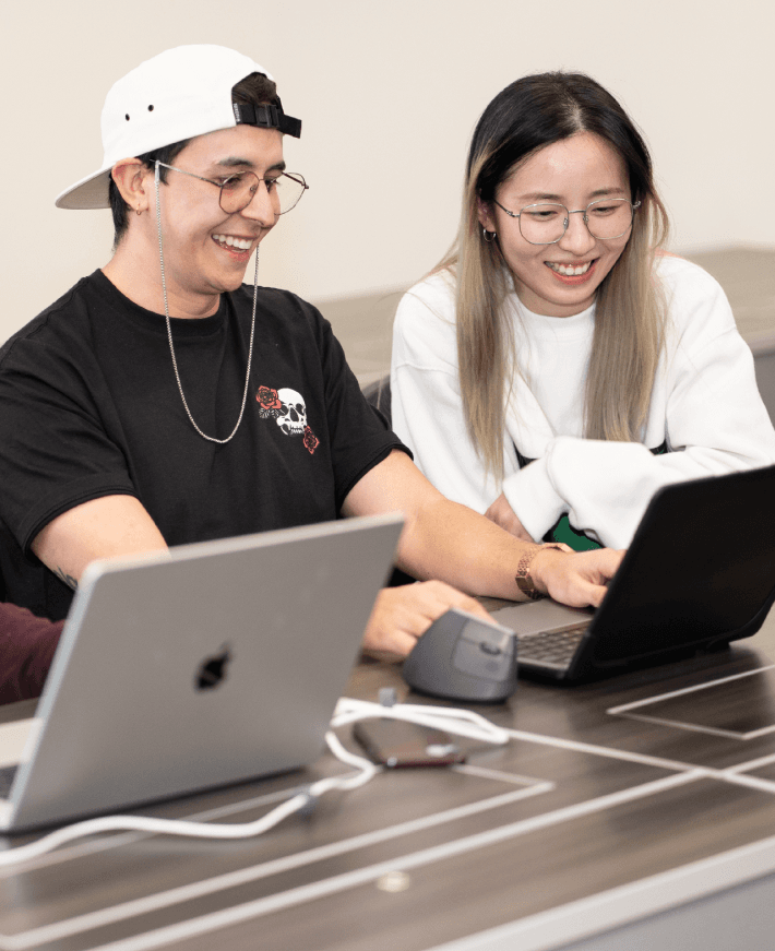 Smiling students discussing application design flow and UX concepts